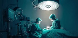 Surgeons performing an operation under bright lights.