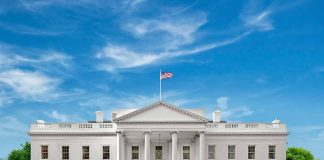 White House with American flag under blue sky