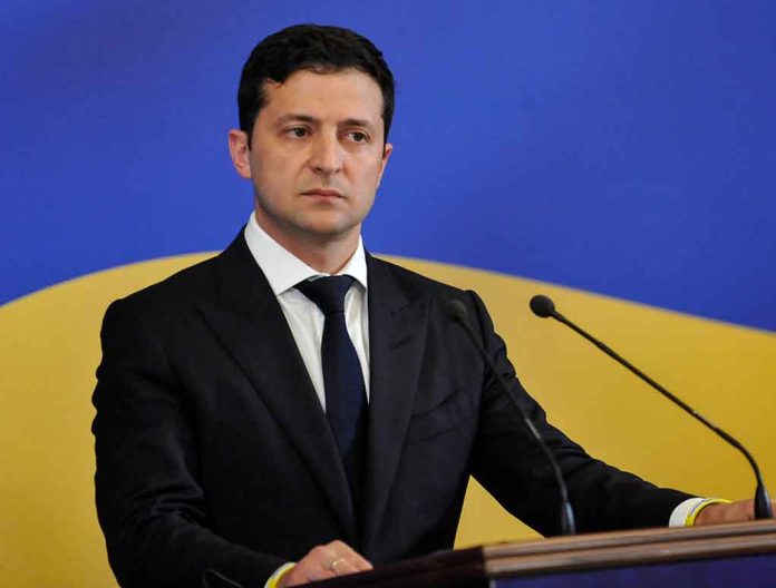 Man in suit speaking at podium with microphones.