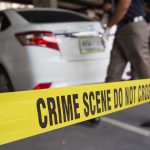 Crime scene with yellow tape and parked car