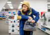 Person in store, hiding something in a bag