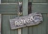 Rustic retired sign on green wooden door
