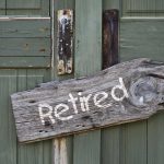 Rustic retired sign on green wooden door