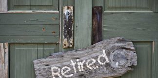 Rustic retired sign on green wooden door