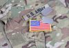 U.S. Army uniform with dog tags and American flag.