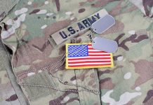 U.S. Army uniform with dog tags and American flag.