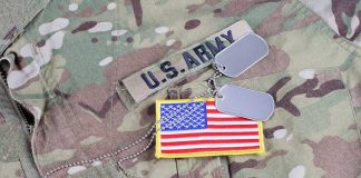 U.S. Army uniform with dog tags and American flag.