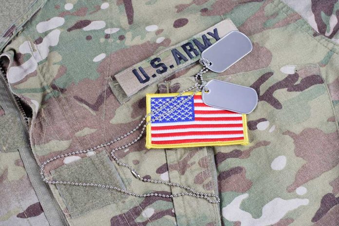 513453070 featured image U.S. Army uniform with dog tags and American flag.