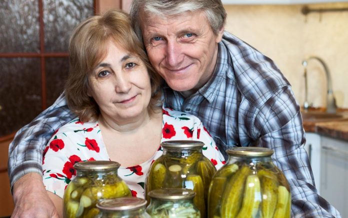 609985676 featured image Older couple smiling with jars of pickles