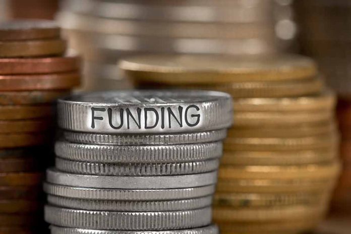 784896787 featured image Stack of coins labeled funding with other coins stacks