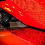 Laptop screen displaying Chinese flag and code