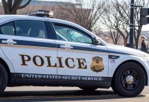 United States Secret Service police car on roadside.