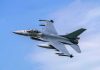 Jet fighter flying through clear blue sky