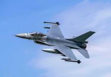 Jet fighter flying through clear blue sky