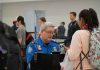 TSA agent checks passenger's documents at airport security