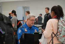TSA agent checks passenger's documents at airport security