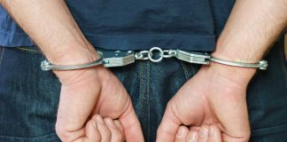 Person in handcuffs behind their back