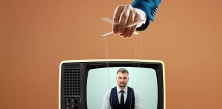 Hand controlling puppet strings on TV broadcast
