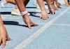 Athletes at starting line on blue track race