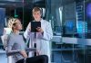 Woman undergoing brain scan with doctor monitoring results