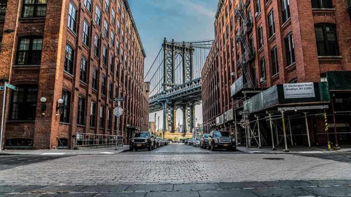 1071270287 Street view with bridge between two brick buildings