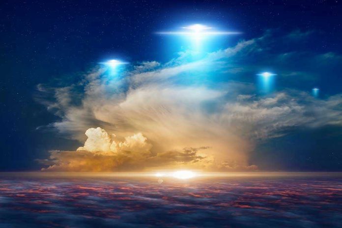 1144721378 Glowing lights above dramatic sunset clouds.