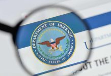Magnifying glass over Department of Defense logo