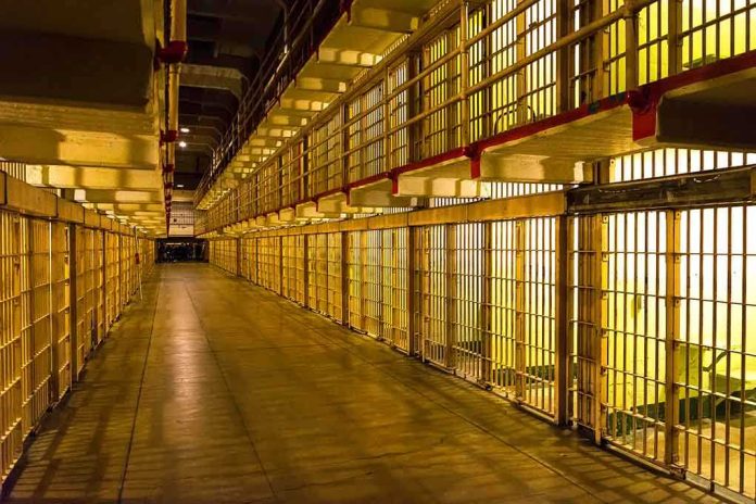 1231860007 featured image Empty hallway between rows of prison cells