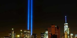 New York City skyline at night with memorial lights