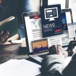 Person reading news on a laptop