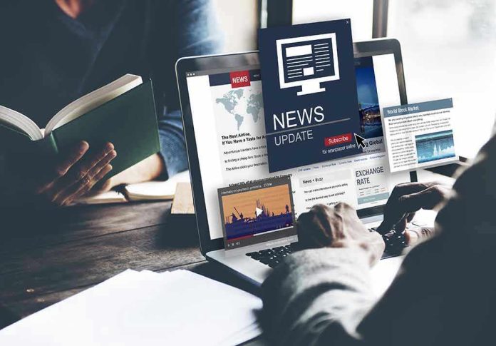 Person reading news on a laptop