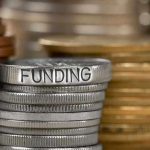 Stack of coins labeled funding with other coins stacks