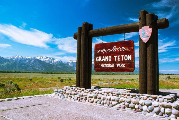 shutterstock_231609118.jpg Entrance sign for Grand Teton National Park with mountains in the background