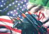 Iran and USA flags with missile launcher