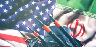 Iran and USA flags with missile launcher