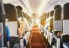 Passengers seated inside an airplane cabin.