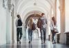 Four students walking in a corridor together.