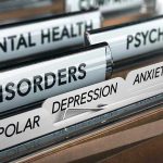 File folders labeled with mental health disorders and psychiatry.