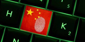 Close-up of a keyboard key featuring the Chinese flag and a fingerprint