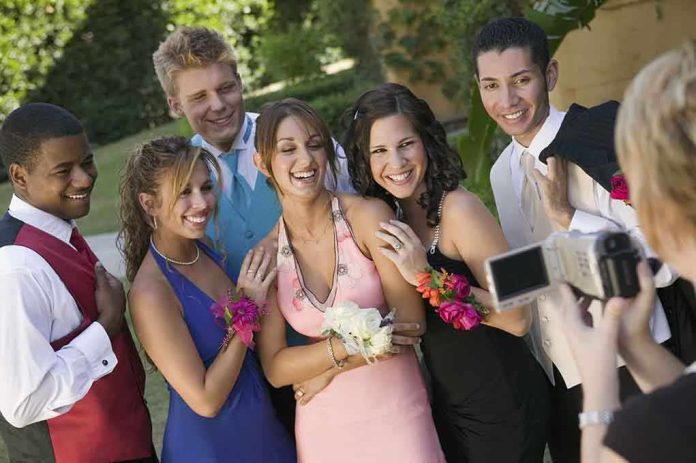 shutterstock_98139134.jpg Group of friends in formal attire posing for a photo during prom night