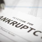 Petition for bankruptcy document with pen.