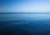 A calm ocean under a clear blue sky