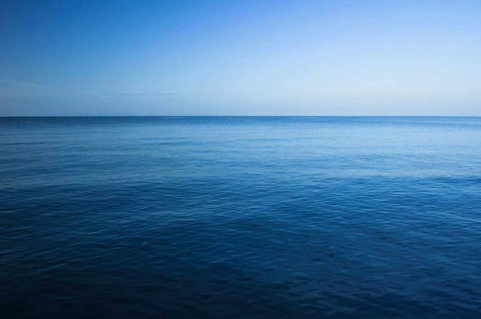 shutterstock_229991677.jpg A calm ocean under a clear blue sky