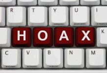 Close-up of a computer keyboard with the word HOAX spelled out in red keys
