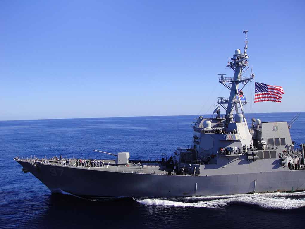 1133692649 featured image Warship sailing with American flag in open sea.