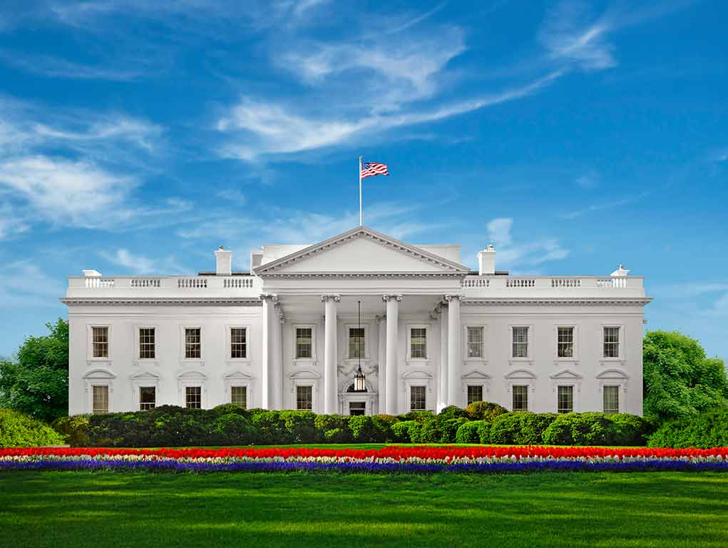 White House with American flag under blue sky
