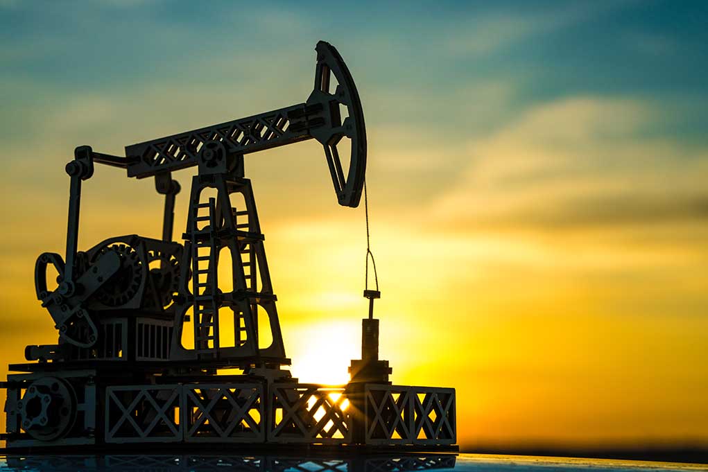 1547602034 featured image Oil pump jack silhouetted against sunset sky.