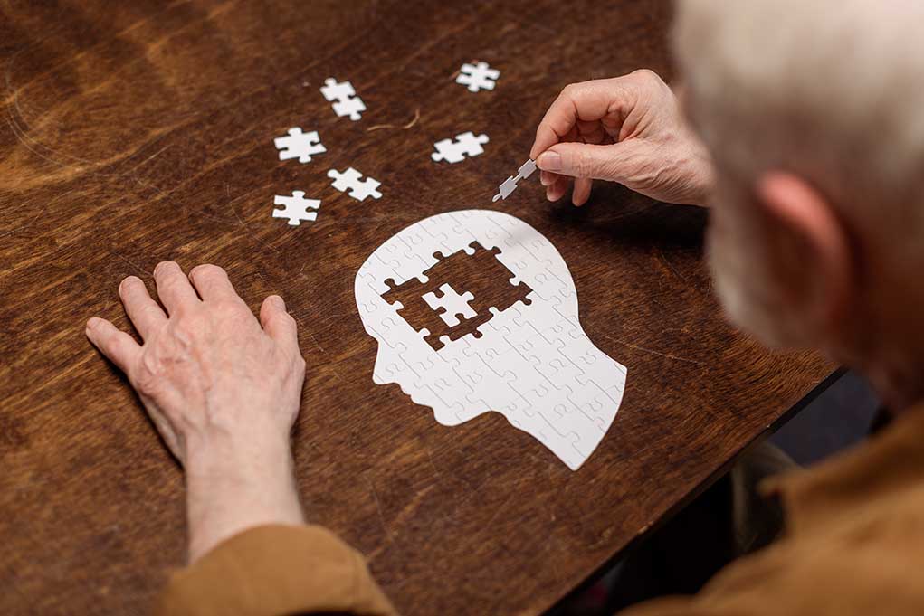 1776503864 featured image Elderly person completing head-shaped jigsaw puzzle.