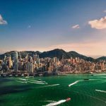 Duterte Arrested After Returning from Hong Kong Aerial view of a coastal city with skyscrapers.