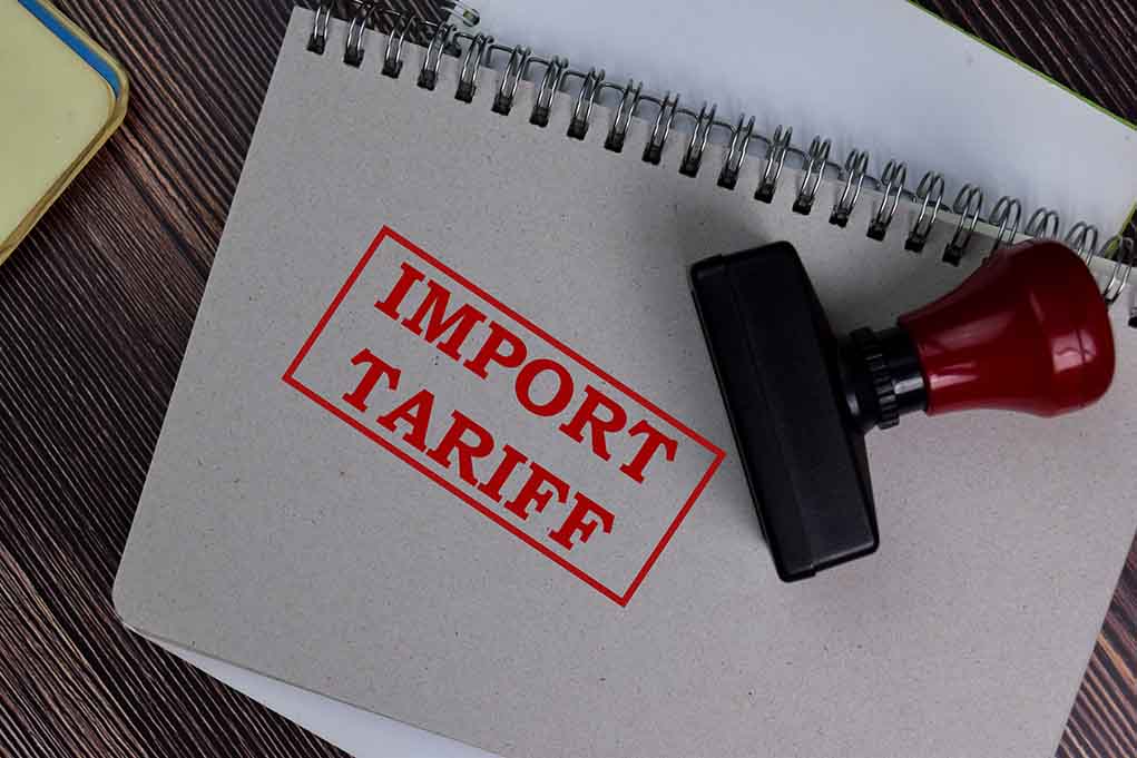 1773748721 featured image Notebook with "Import Tariff" stamp and rubber stamper.